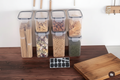 Flat lay of multiple clear storage containers with colorful ingredients on kitchen counter